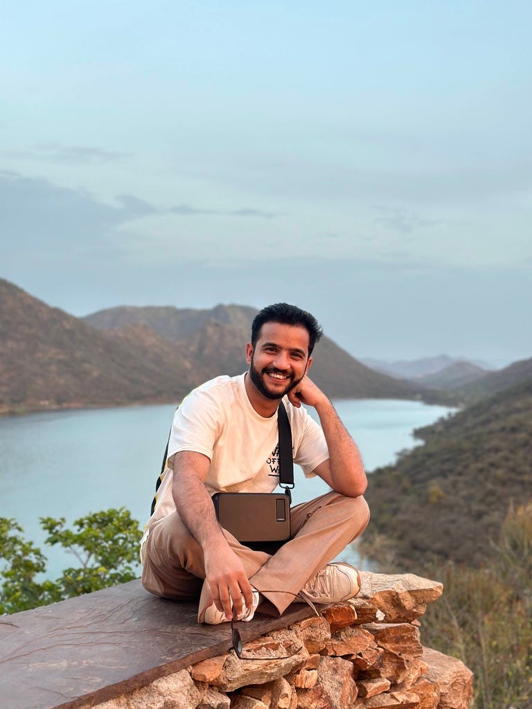 Author sitting on a rock at the end of the mountain.